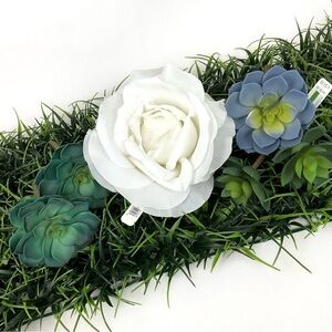 Faux florals, grass pads, greenery succulents and jumbo rose decor